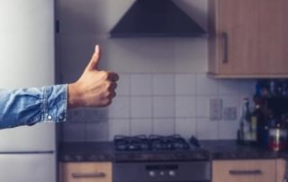 Thumbs up in clean and tidy kitchen