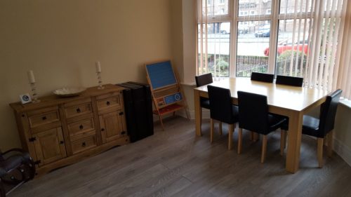 DIning table and front room in a home stay hosts