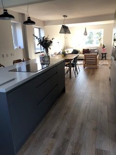 Kitchen and living room in a home say hosts family accommodation