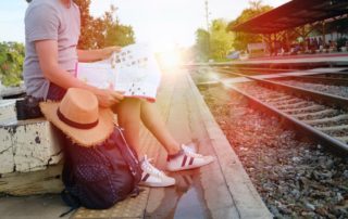 Student looking at map and waiting for a train