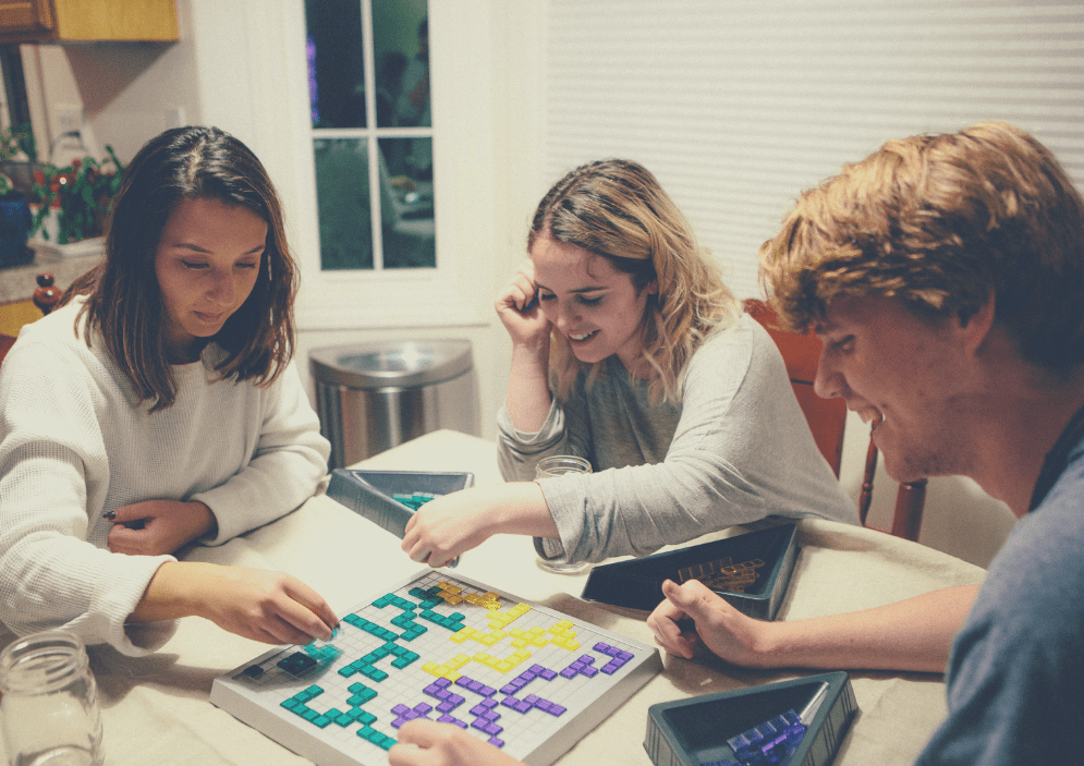 Student and home stay family hosts playing board games
