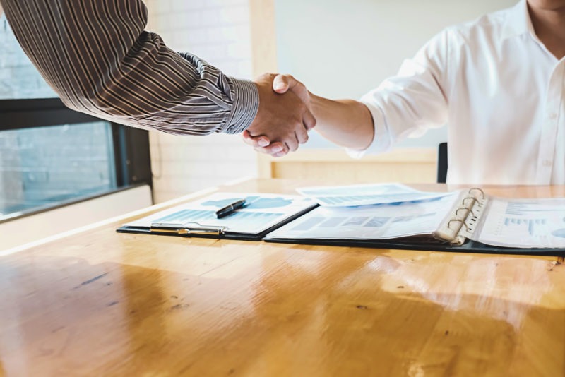 Student shaking hands with their tutor